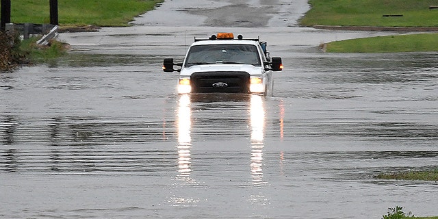 A pickup truck drives on a flooded street in Enid, Okla., Monday, May 20, 2019. An intense storm system that weather forecasters labeled "particularly dangerous" swept through the Southern Plains Monday, spawning a few tornadoes that caused some damage and a deluge of rain but no reports of injuries.
