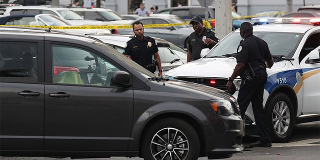 Sunny Isles Beach police officers examine the scene of a shooting near the Trump International Beach Resort Sunday afternoon. (Joe Raedle/Getty Images)
