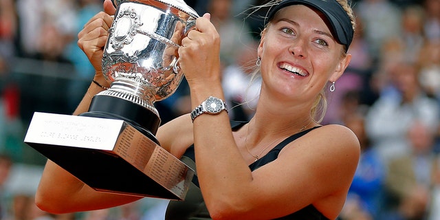 Maria Sharapova of Russia holds the trophy after winning the women's final match against Sara Errani of Italy at the French Open tennis tournament in Roland Garros stadium in Paris. (AP Photo/Michel Euler, File)