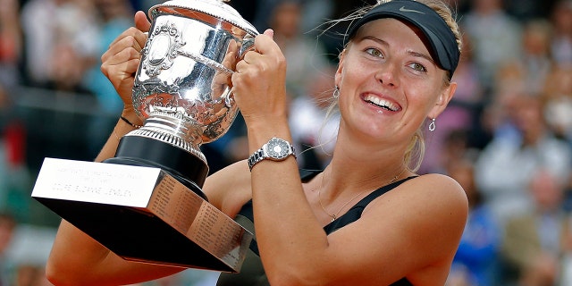 Maria Sharapova of Russia holds the trophy after winning the women's final match against Sara Errani of Italy at the French Open tennis tournament in Roland Garros stadium in Paris. (AP Photo/Michel Euler, File)