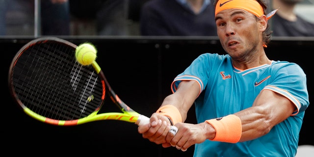 Rafael Nadal of Spain returns the ball to Novak Djokovic of Serbia during their final match at the Italian Open tennis tournament, in Rome, Sunday, May 19, 2019. (AP Photo/Gregorio Borgia)