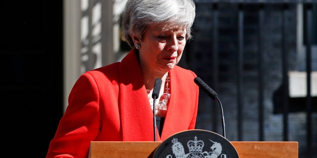 British Prime Minister Theresa May reacts as she turns away after making a speech in the street outside 10 Downing Street in London, England, Friday, May 24, 2019. Theresa May says she'll quit as UK Conservative leader on June 7, sparking contest for Britain's next prime minister.