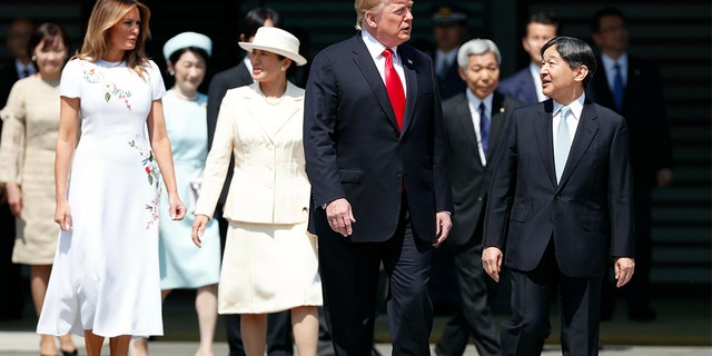 President Trump and first lady Melania Trump, escorted by Japan's Emperor Naruhito, front right, and Empress Masako, fourth left, during the welcome ceremony at the Imperial Palace in Tokyo.