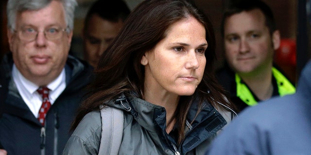 Former University of Southern California soccer coach Laura Janke departs federal court, Tuesday, May 14, 2019, in Boston, where she pleaded guilty to charges in a nationwide college admissions bribery scandal. (AP Photo/Steven Senne)