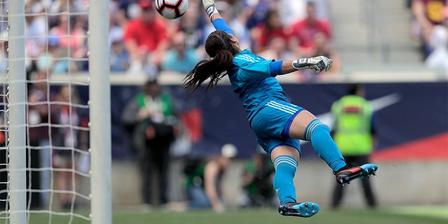 Mexico goalkeeper Cecilia Santiago diving at a shot by U.S. forward Megan Rapinoe. The shot went wide of the goal. (AP Photo/Julio Cortez)