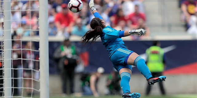 Mexico goalkeeper Cecilia Santiago diving at a shot by U.S. forward Megan Rapinoe. The shot went wide of the goal. (AP Photo/Julio Cortez)