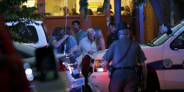 Family members gather outside the Princess Anne Middle School in Virginia Beach, Va, on Friday, May 31, 2019. (AP Photo/Vicki Cronis-Nohe)