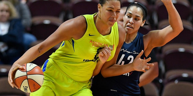 Dallas Wings' Liz Cambage, left, drives against Connecticut Sun's Brionna Jones during a preseason WNBA basketball game in Uncasville, Conn. (AP Photo/Jessica Hill, File)