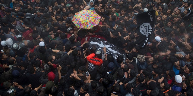 Kashmiri villagers carry the body of Zakir Musa, a top militant commander linked to al-Qaida, as it rains during his funeral procession in Tral, south of Srinagar, Indian controlled Kashmir, Friday, May 24, 2019. (AP Photo/Dar Yasin)
