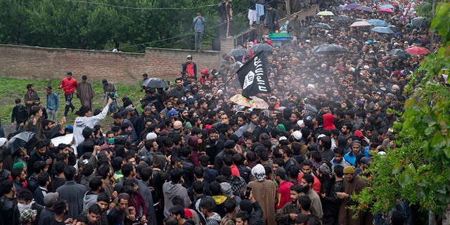 Kashmiri villagers carry the body of Zakir Musa, a top militant commander linked to al-Qaida, as it rains during his funeral procession in Tral, south of Srinagar, Indian controlled Kashmir, Friday, May 24, 2019. (AP Photo/Dar Yasin)