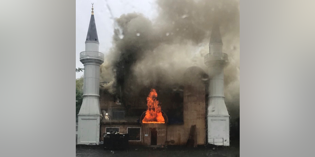 In this photo provided by Lina Biroscak, a fire burns at a mosque, Sunday, May 12, 2019, in New Haven, Conn. It was not immediately clear what caused the fire. (Lina Biroscak via AP)