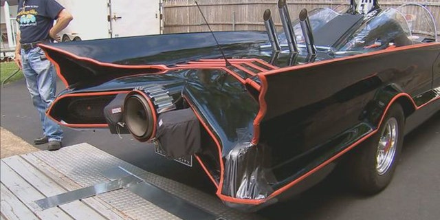 Bill Gibson has tricked out the car with a bat phone, rocket launchers, and projector that shows the bat symbol on the road at night.