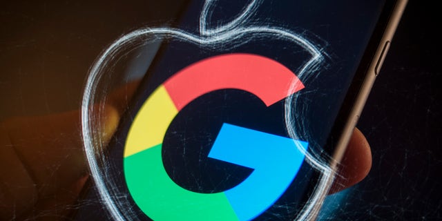 An Apple iPhone with a Google logo is seen in this photo illustration on December 6, 2017.