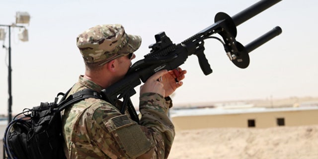 A soldier uses the Drone Defender to counter enemy drones. (Courtesy of U.S. Army)