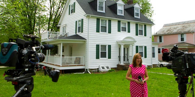 Television crews report a form in front of Baltimore Mayor Catherine Pugh's home in Baltimore, MD on Thursday, April 25, 2019.