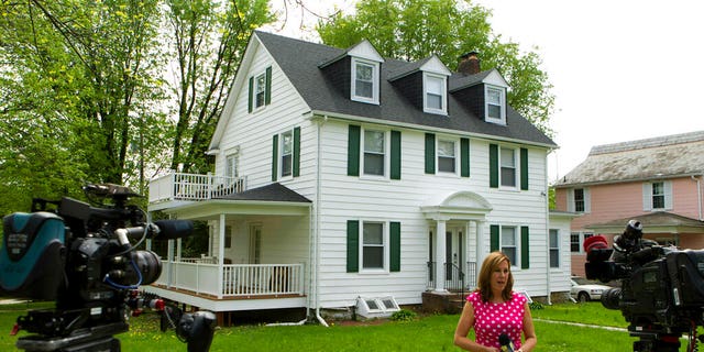TV crews report form outside the house of Baltimore Mayor Catherine Pugh in Baltimore, MD., Thursday, April 25, 2019.