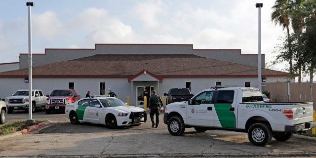In this June 23, 2018 file photo, a U.S. Border Patrol Agent walks between vehicles outside the Central Processing Center in McAllen, Texas.
