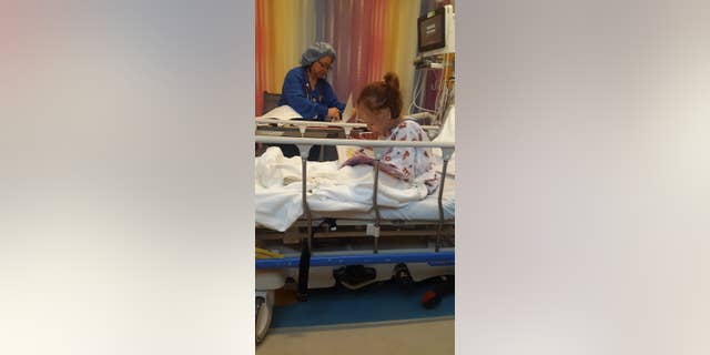 Ayesha, 8, doing her homework before surgery