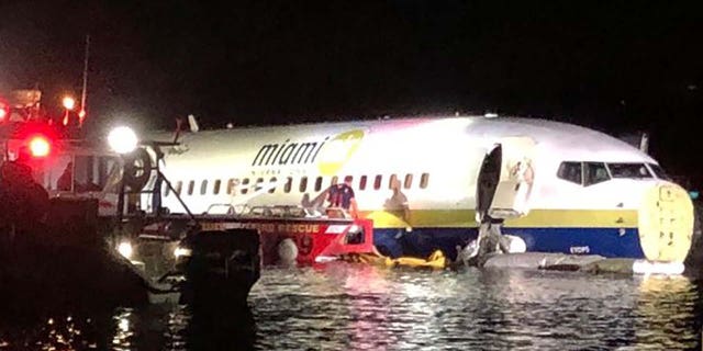 A Miami Air International jet is seen in the St. Johns River in Jacksonville, Fla., on Friday night after sliding off a runway. (Jacksonville Sheriff's Office)