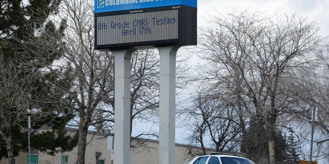 In this April 17, 2019, file photo, a patrol car is parked in front of Columbine High School in Littleton, Colo., where two student killed 12 classmates and a teacher in 1999.