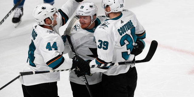 San Jose Sharks defenseman Marc-Edouard Vlasic, left, celebrates with center Gustav Nyquist and center Logan Couture, right, after his goal against the Colorado Avalanche during the third period of Game 3 of an NHL hockey second-round playoff series Tuesday, April 30, 2019, in Denver. The Sharks won 4-2. (AP Photo/David Zalubowski)