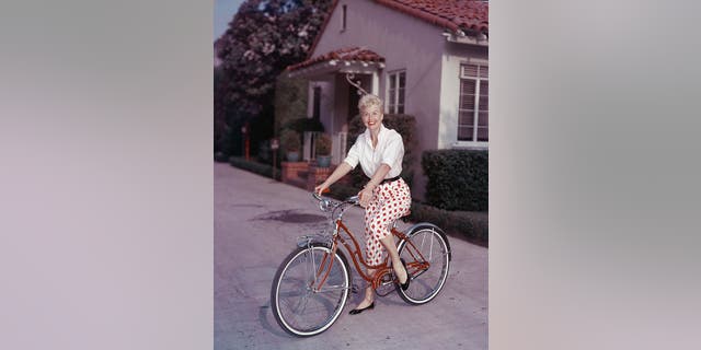 American actor Doris Day poses on a red Schwinn bicycle, late 1950s. (Photo by Hulton Archive/Getty Images)