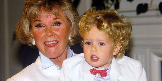 Doris Day poses with her grandson Ryan Melcher, then 4, the son of her only child Terry Melcher at a press conference at the hotel she owns in Carmel, Calif., on July 16, 1985. Day passed away on Monday.