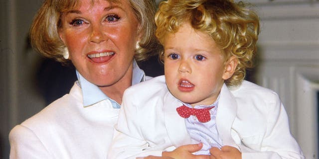 Doris Day poses with her grandson Ryan Melcher, then 4, the son of her only child Terry Melcher at a press conference at the hotel she owns in Carmel, Calif., on July 16, 1985. Day passed away on Monday.