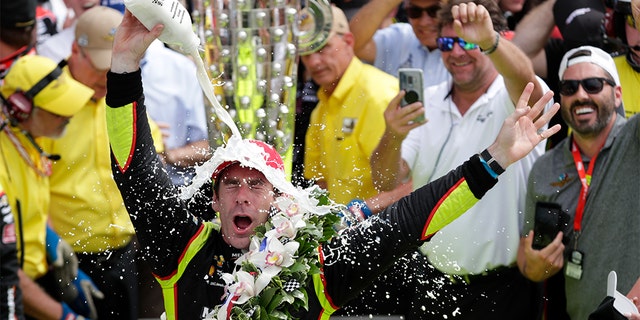 Simon Pagenaud, of France, celebrates after winning the Indianapolis 500 IndyCar auto race at Indianapolis Motor Speedway, Sunday, in Indianapolis. (AP Photo/Michael Conroy)