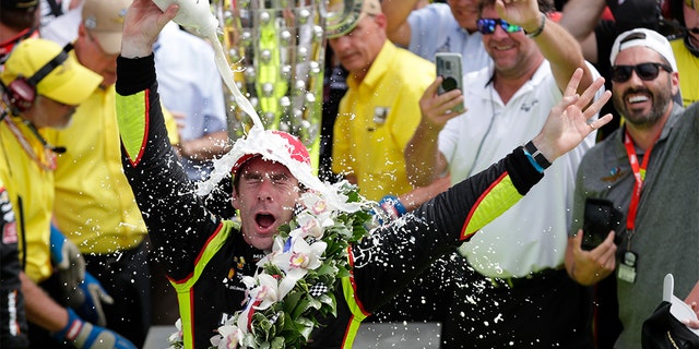 Simon Pagenaud, of France, celebrates after winning the Indianapolis 500 IndyCar auto race at Indianapolis Motor Speedway, Sunday, in Indianapolis. (AP Photo/Michael Conroy)