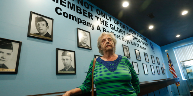 In this May 6, 2019, photo, Marguerite Cottrell, sister of John Reynolds, speaks during an interview at a recently opened tribute center for the Bedford Boys in Bedford, Va. Reynolds, had been killed in the D-Day invasion of Normandy on the coast of France. The 75th anniversary of the D-Day invasion of Normandy has a solemn significance for the small town of Bedford, who lost 20 local men. (AP Photo/Steve Helber)