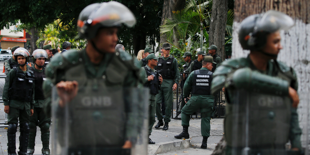 Venezuelan Bolivarian National stand guard around the National Assembly building as the opposition-controlled congress met to discuss a move could provide political cover for greater international involvement in the nation's crisis, in Caracas, Venezuela, Tuesday, May 7, 2019. Military police prevented journalists from entering the National Assembly, and some reporters were harassed by government supporters outside the building. (AP Photo/Fernando Llano)