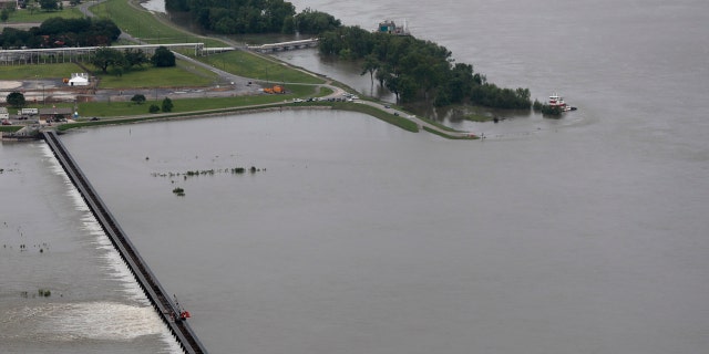 Workers open bays of the Bonnet Carre Spillway, to divert rising water from the Mississippi River to Lake Pontchartrain, upriver from New Orleans, in Norco, La., Friday, May 10, 2019.