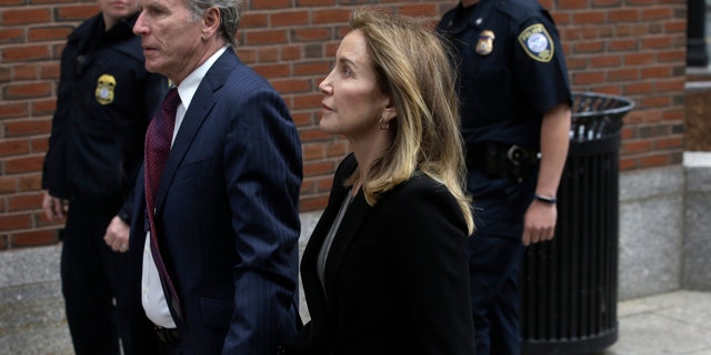 Actress Felicity Huffman arrives with her brother Moore Huffman Jr., at federal court Monday, May 13, 2019, in Boston, where she pleaded guilty.
