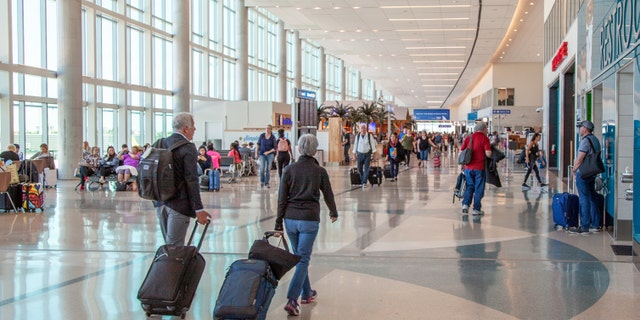 A shot of travelers passing through Fort Lauderdale airport.