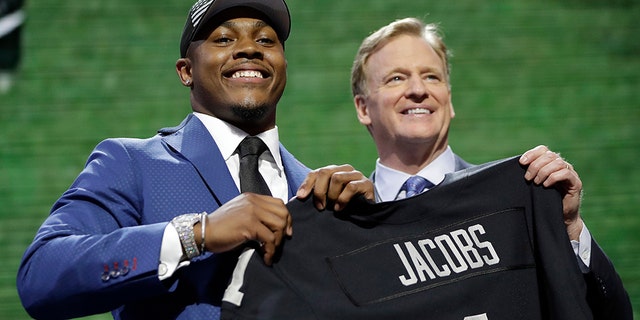 Alabama running back Josh Jacobs poses with NFL Commissioner Roger Goodell after the Oakland Raiders selected Jacobs in the first round at the NFL football draft, Thursday, April 25, 2019, in Nashville, Tenn.(AP Photo/Mark Humphrey)