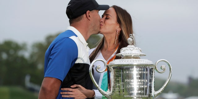 Brooks Koepka, left, kisses his girlfriend Jena Sims after winning the PGA Championship golf tournament. (AP)