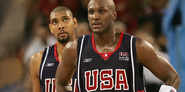 Lamar Odom #14 and teammate Tim Duncan #13 of the United States walk back to their bench during a timeout in the final minutes against Lithuania in a men's basketball preliminary game on August 21, 2004 during the Athens 2004 Summer Olympic Games.