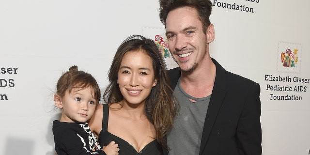 Mara Lane and Jonathan Rhys Meyers pose with son Wolf in October 2018. The family was reportedly on a plane with Alki David when the Coca-Cola heir was arrested.