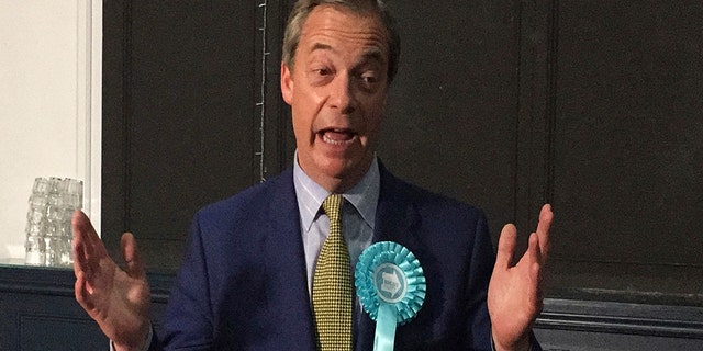 Brexit Party leader Nigel Farage gestures, during his party's rally at the Corn Exchange, in Edinburgh, Friday May 17, 2019. (Tom Eden/PA via AP)
