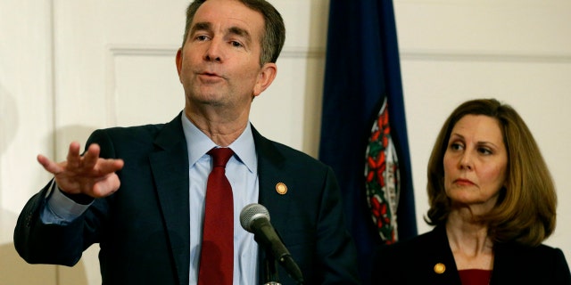 FILE - In this Feb. 2, 2019 file photo, Virginia Governor Ralph Northam, left, gestures as his wife, Pam, listens during a press conference at the Governors Mansion at the Capitol in Richmond, in Virginia. (AP Photo/Steve Helber, File)