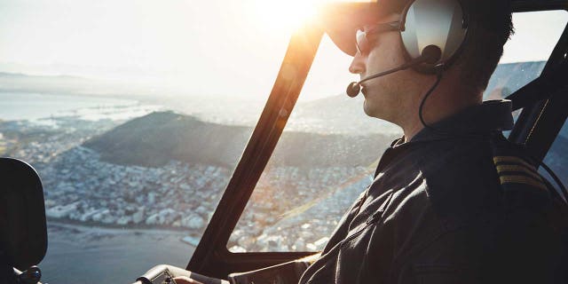 A stock image of a pilot flying a plane.