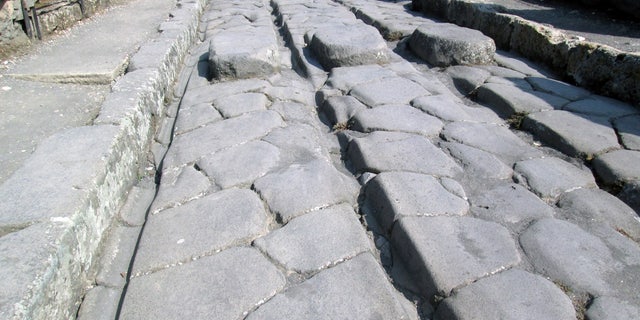 The passage of carts over decades could cause ruts (like the one shown here), particularly in high-traffic areas of Pompeii.