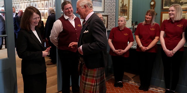 Like any charming bed-and-breakfast, family photos fill the halls — though the people pictured are largely royal.