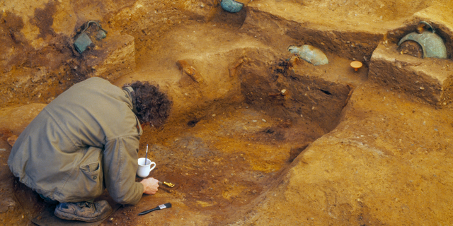 An archaeologist carefully excavates the Prittlewell burial chamber. The chamber was discovered in 2003; it has taken researchers 16 years to carefully remove, clean and analyze the artifacts. Many will now be on permanent display at the Southend Central Museum in Southend-on-Sea, England.