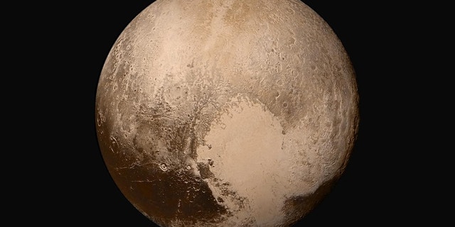Four images from NASA’s New Horizons’ Long Range Reconnaissance Imager (LORRI) were combined with color data from the Ralph instrument to create this global view of Pluto. Credit: NASA/Johns Hopkins University Applied Physics Laboratory/Southwest Research Institute.