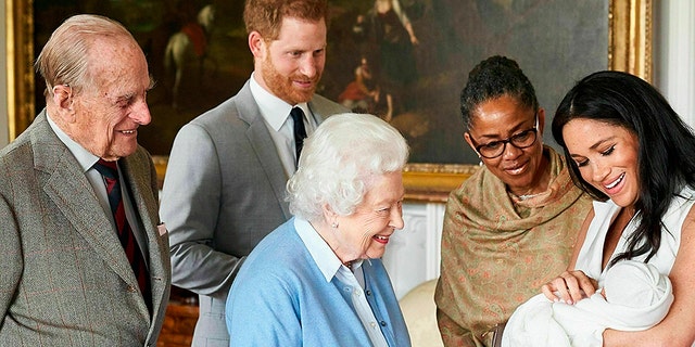 British princes Harry and Meghan, Duchess of Sussex, accompanied by her mother Doria Ragland, show their new son to Queen Elizabeth II and Prince Philip at Windsor Castle in Windsor, England. (Chris Allerton / SussexRoyal via AP)