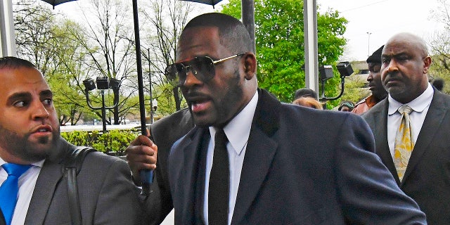 Musician R. Kelly, center, arrives at the Leighton Criminal Court building for a hearing Tuesday, May 7, 2019, in Chicago.