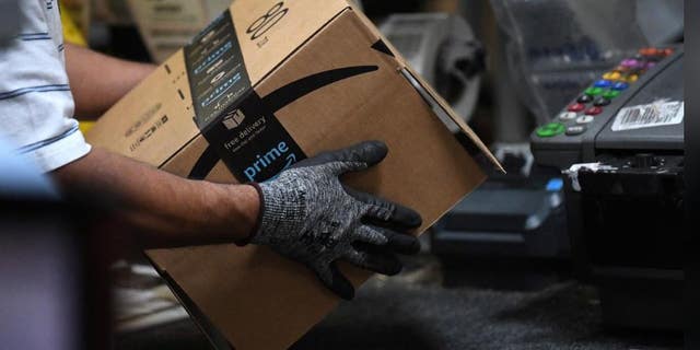 A worker assembles a box to be delivered to the Amazon Distribution Center in Baltimore, Maryland, United States, on April 30, 2019.