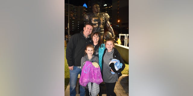 Happier times: Rich and his wife Megan, with their two daughters.